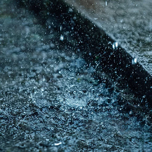 Rainwater flowing along a gutter